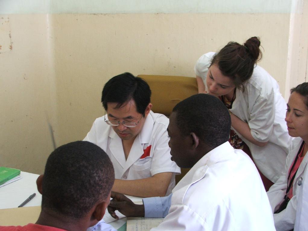 2011年7月22日，在坦桑尼亞桑給巴爾納茲莫加醫(yī)院外科門診，中國第24批援桑給巴爾醫(yī)療隊(duì)隊(duì)長盧建林為當(dāng)?shù)鼗颊咴\治并帶教實(shí)習(xí)生。新華社發(fā)（國家衛(wèi)生健康委供圖）