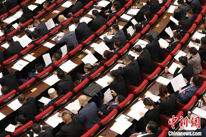 圖為會議現(xiàn)場，參會代表正在聽取政府工作報告?！∑钤鲚?攝