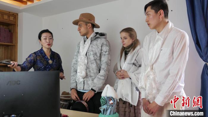 圖為圖為主播白瑪旺姆為留學生介紹直播流程?！≈x牧 攝