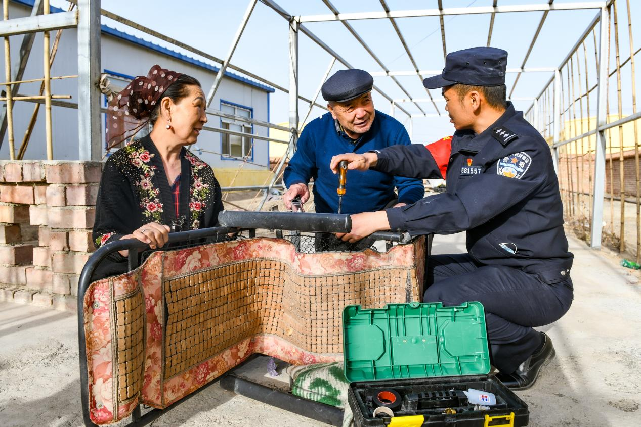 下馬崖邊境派出所民警何春明在轄區(qū)群眾家中維修躺椅。下馬崖邊境派出所供圖