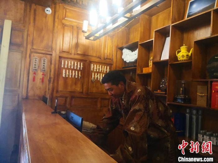 圖為桑杰才讓用電腦處理財(cái)務(wù)。　史靜靜 攝