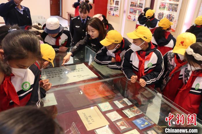 圖為亞東邊檢站民警為駐地小學(xué)生講解該站榮譽(yù)發(fā)展史。　胡利媛 攝